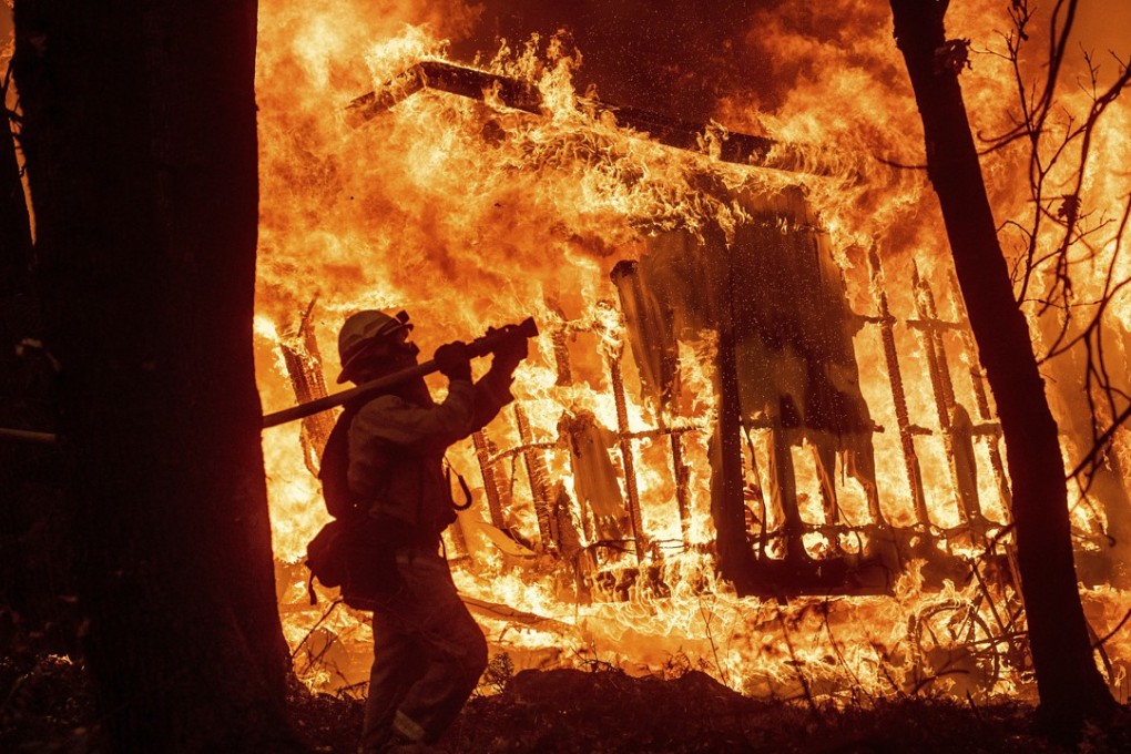 Flames from the Camp Fire consume a home in California on November 9. There is a link between climate change and bigger fires in California. Photo: AP