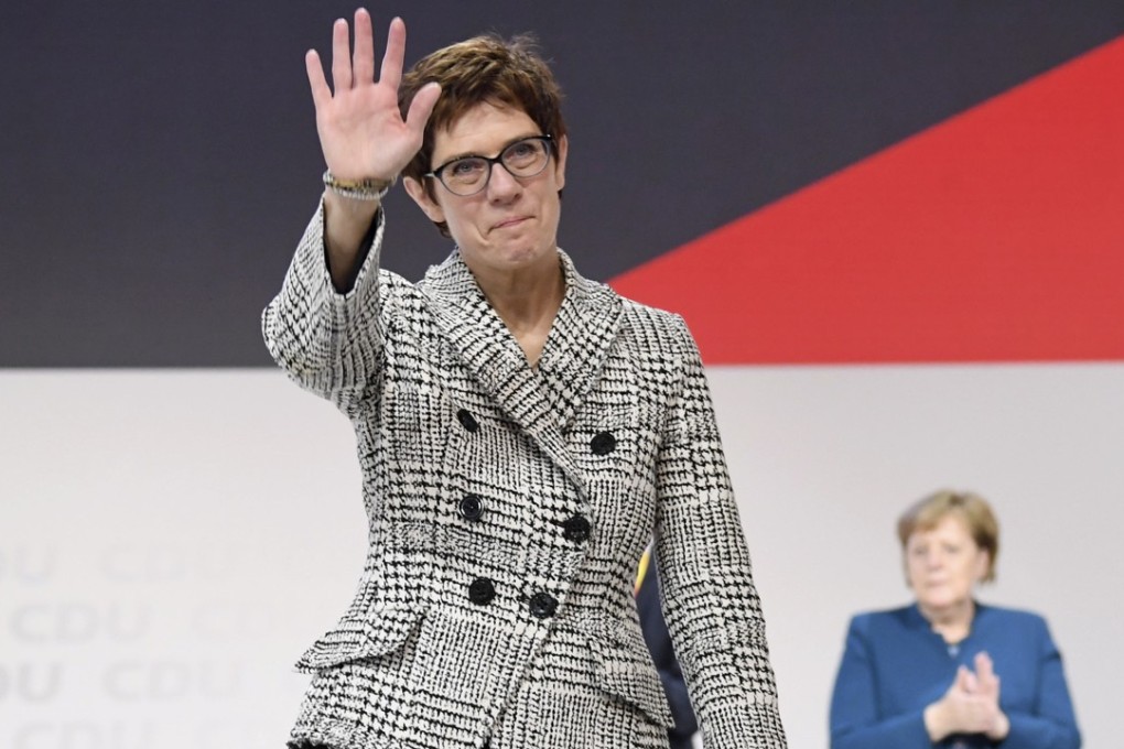 Annegret Kramp-Karrenbauer waves in front of German Chancellor Angela Merkel, after the run-off of the election of a new party leader during the 31st Party Congress of the Christian Democratic Union (CDU) in Hamburg, Germany on Friday. Photo: EPA-EFE