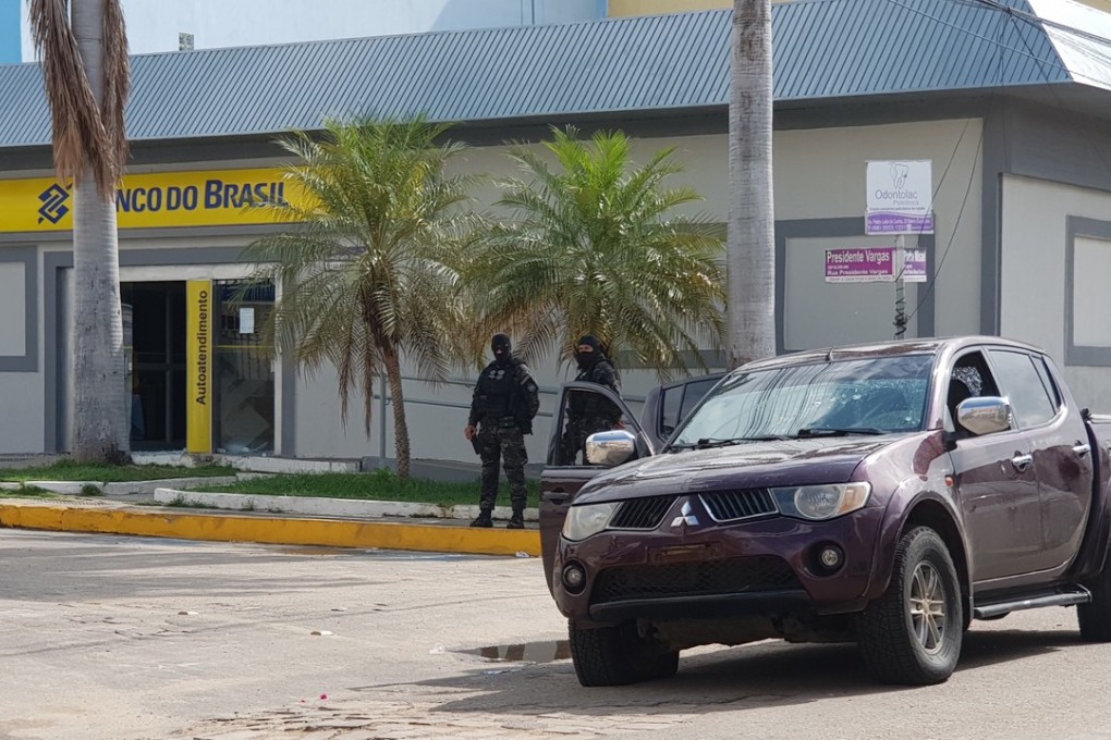 Police officers guard a bank after a shooting in Milagres, Brazil on December 7, 2018. Photo: EPA
