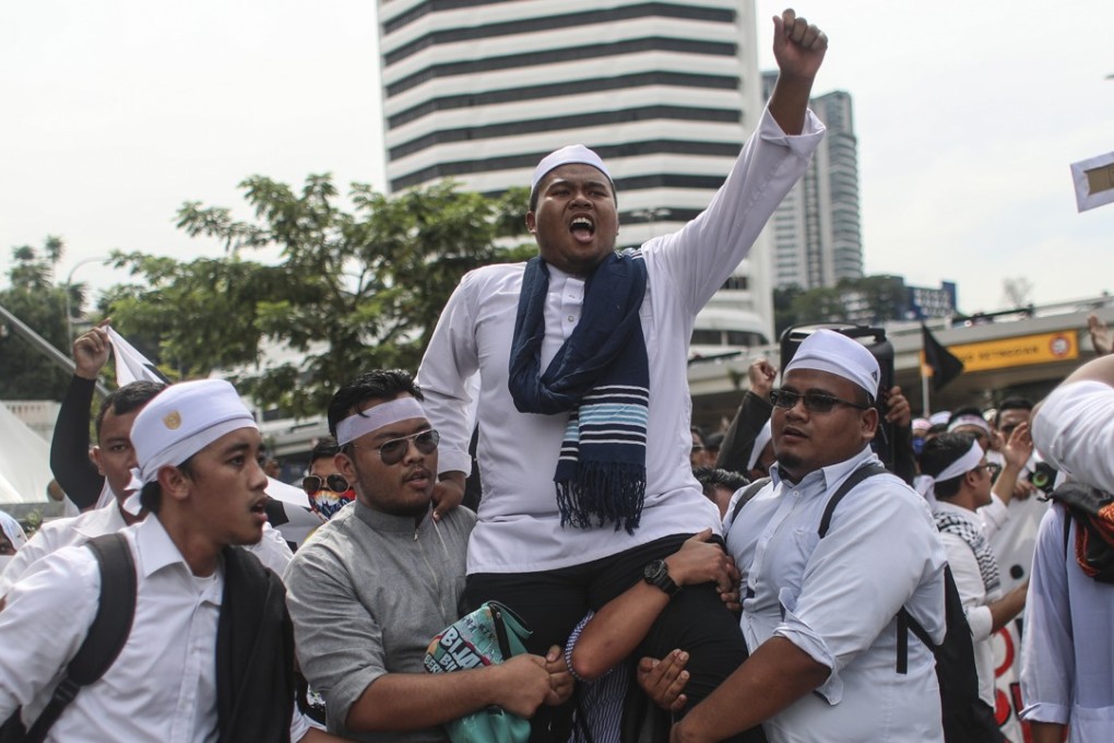 A man shouts at the rally in Kuala Lumpur. Photo: EPA