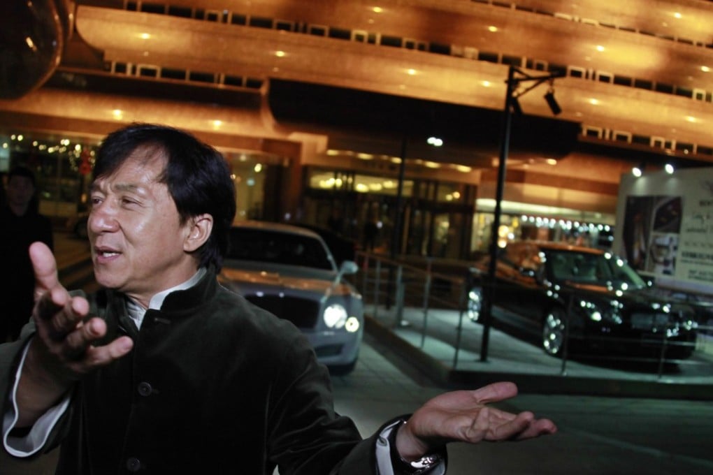 Kung Fu superstar Jackie Chan gestures as he speaks to the media before having his Bentley 666 auctioned for charity in Beijing on November 19, 2012. Photo: Reuters