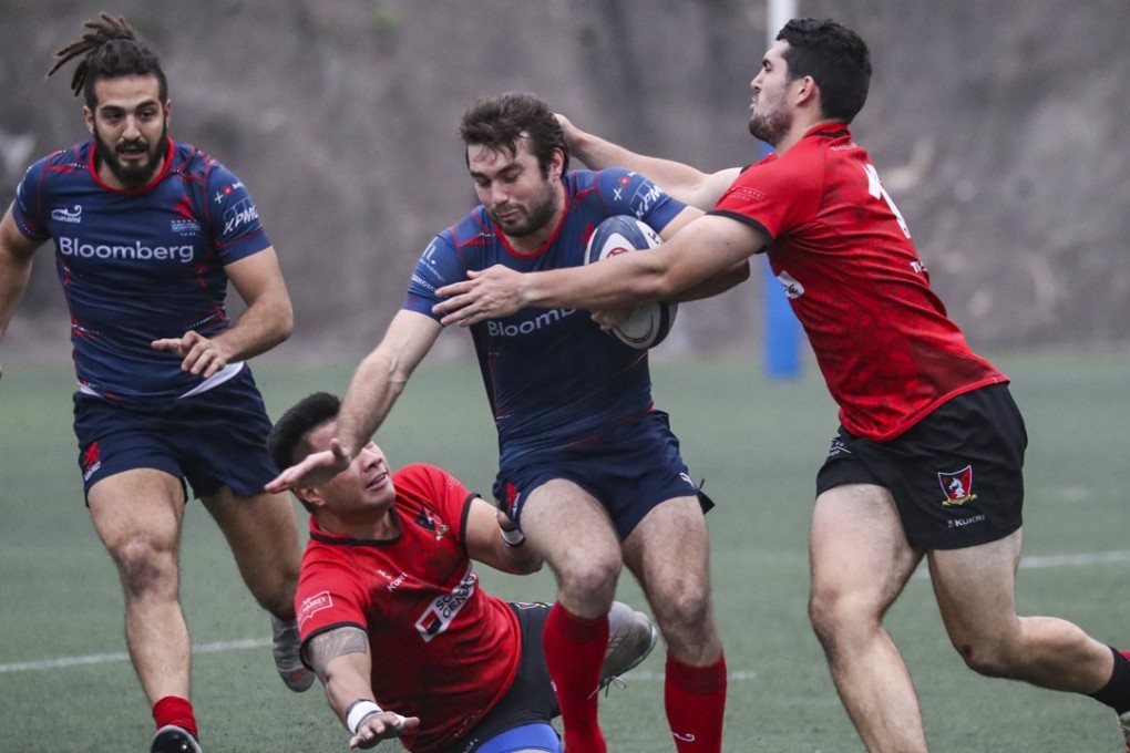Sean Taylor of Scottish HK (blue) in action during a game against Societe General Valley at Shek Kip Mei Park in Sham Shui Po. Photo: Edward Wong