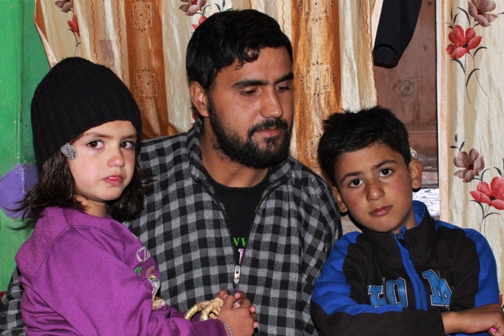 Khursheed Ahmad Sheikh with his son Misbah Khursheed, 7, and daughter Aalima Jan, 5. Photo: Saqib Mir