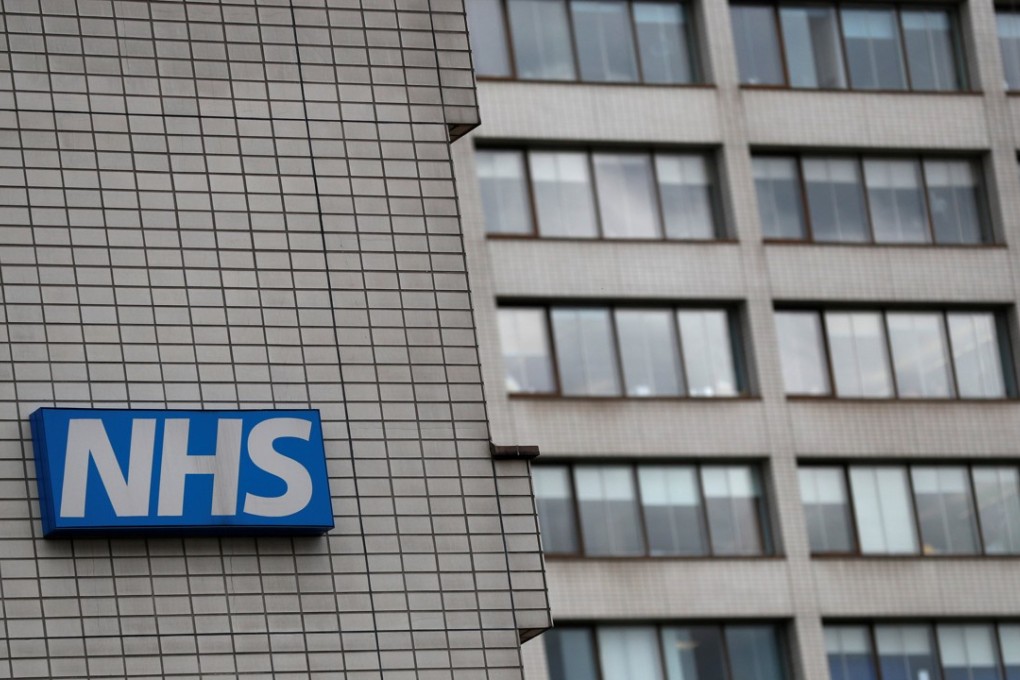 File photo of an NHS sign on a hospital in central London. Photo: Reuters