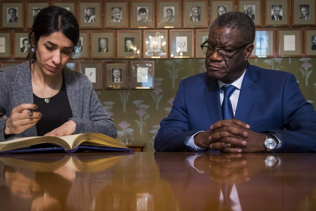 Denis Mukwege from Congo and Nadia Murad from Iraq sign the Nobel guestbook. Both won the Nobel Peace Prize for their efforts to end the use of sexual violence as a weapon of war. Photo: EPA
