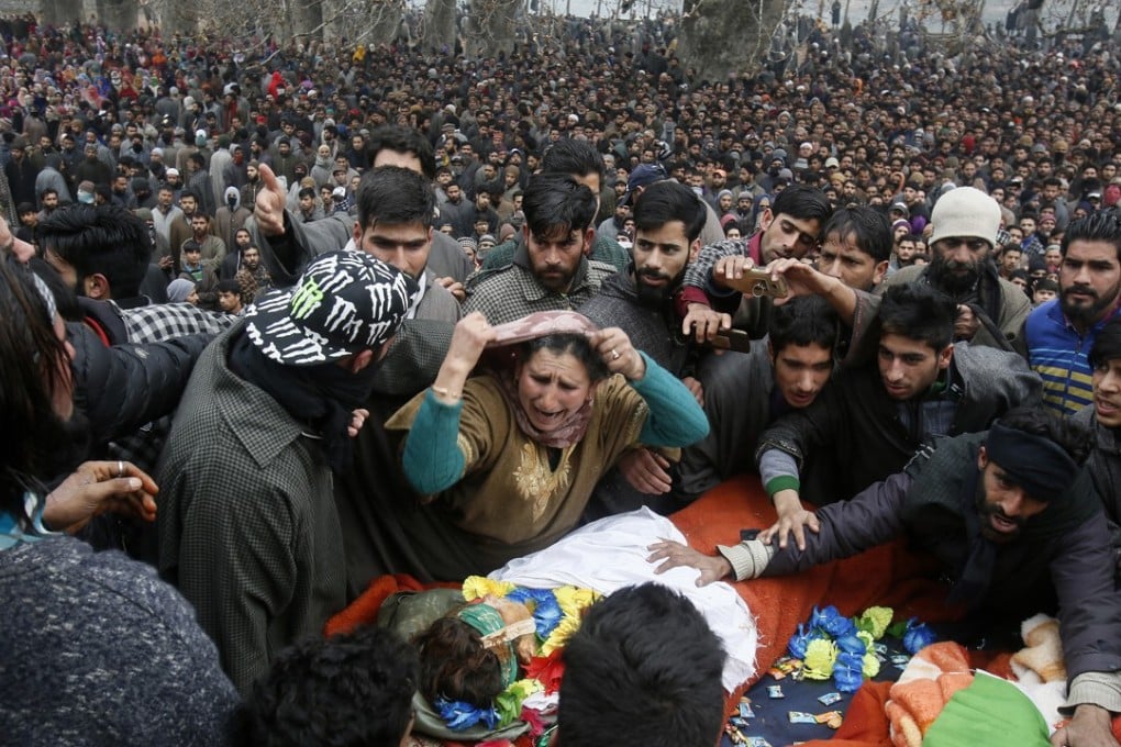 A relative weeps near the body of Mudasir Rashid Parray during joint funeral. Photo: AP