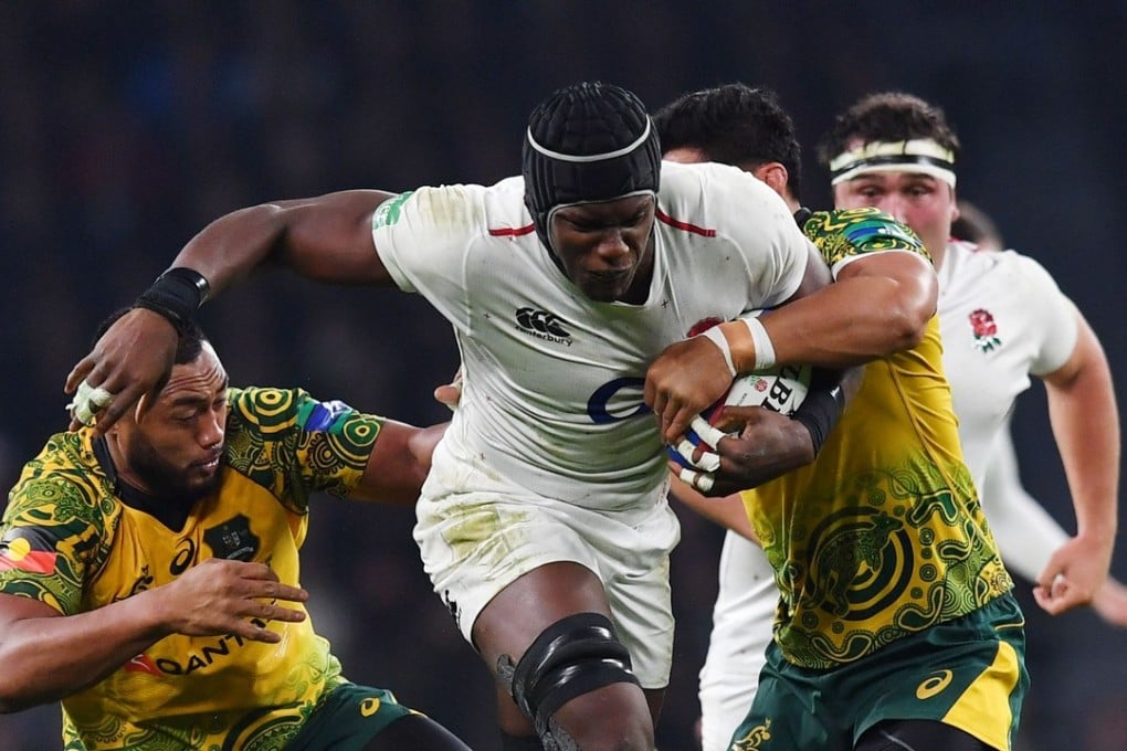 England lock Maro Itoje (centre) is tackled by Australia prop Sekope Kepu (left) during the test match between England and Australia at Twickenham in November. Photo: AFP