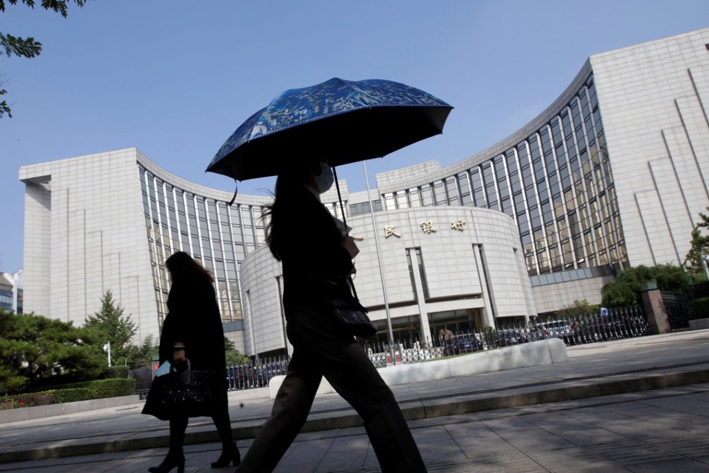 People walk past the headquarters of the People's Bank of China (PBOC), the central bank, in Beijing. Photo: Reuters