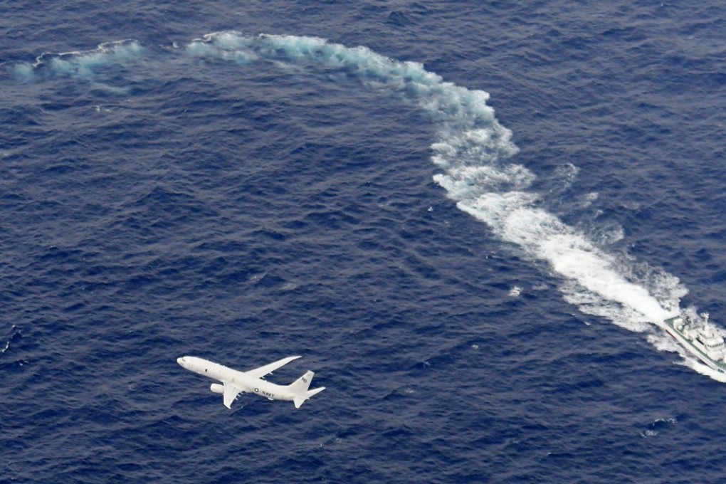 A Japanese Coast Guard vessel and US military plane during the search and rescue operation. Photo: Kyodo