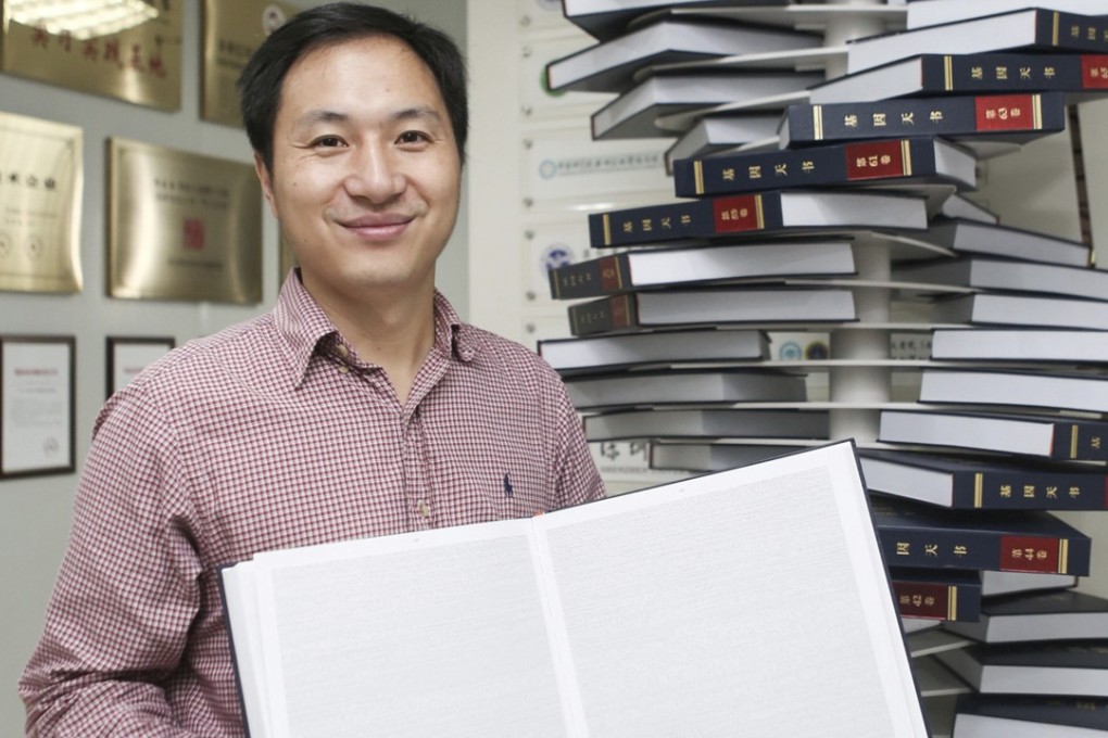 Scientist He Jiankui, who sparked controversy with his announcement that he had altered the genetic material of twin girls before birth, poses with The Human Genome, a book he edited, at his company Direct Genomics in Shenzhen, China, in August 2016. Photo: Reuters