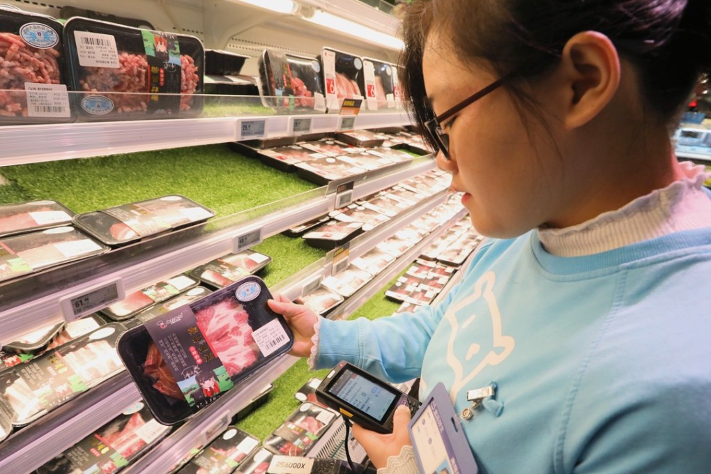 A shop assistant looks at packaged meat in a Hema Supermarket in Shanghai on November 10, 2018. Photo: SCMP/Simon Song