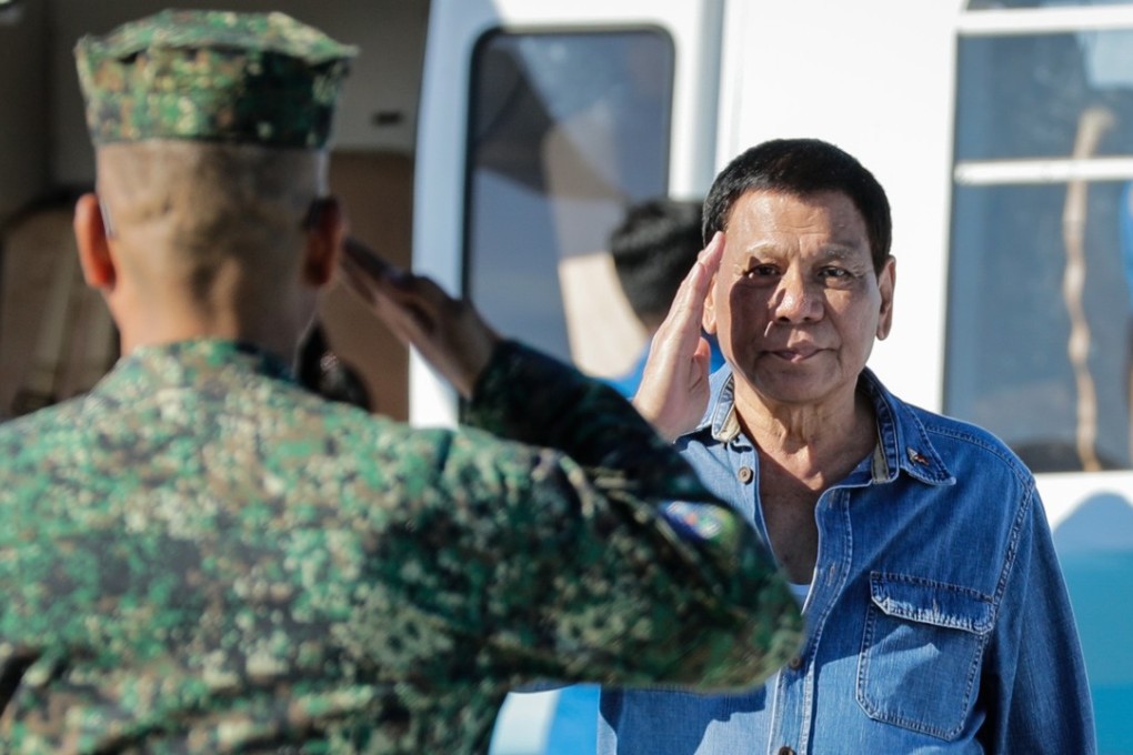President Rodrigo Duterte salutes a military officer. Photo: EPA