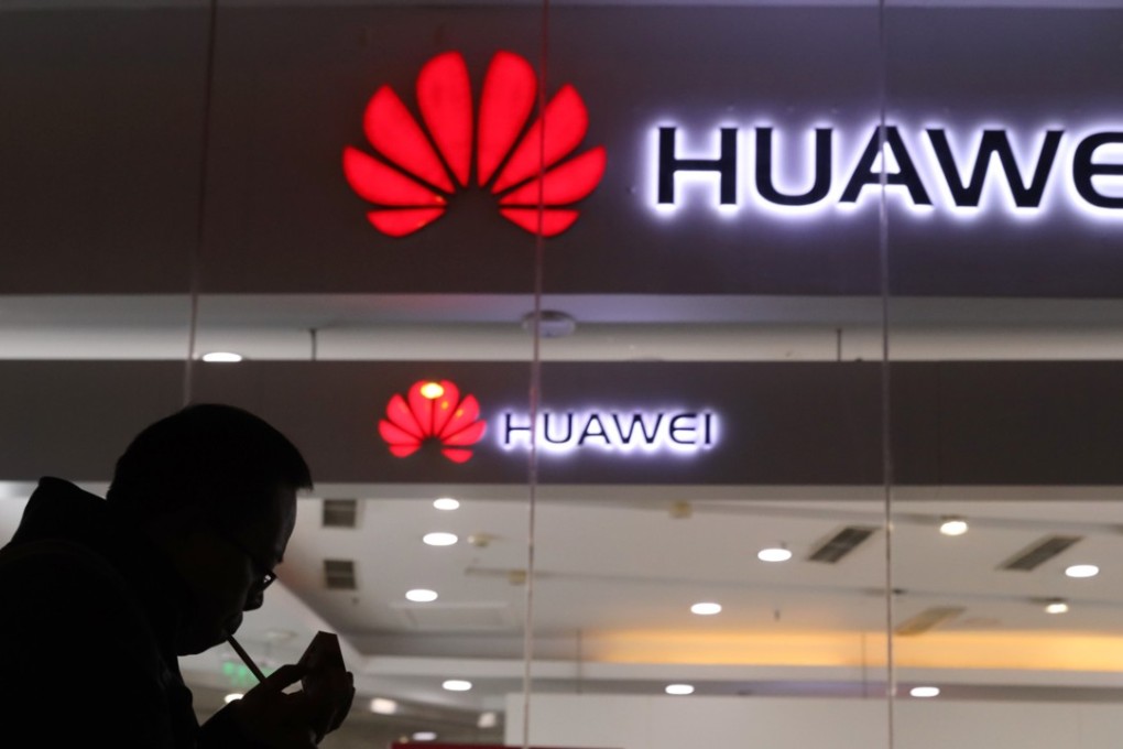 A man lights a cigarette outside a Huawei retail shop in Beijing on Thursday. The arrest of Huawei’s CFO on Saturday may be a US tactic in the ongoing trade war, analysts say. Photo: AP