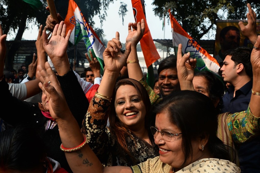 Indian National Congress supporters celebrate outside the party headquarters in New Delhi. Photo: AFP
