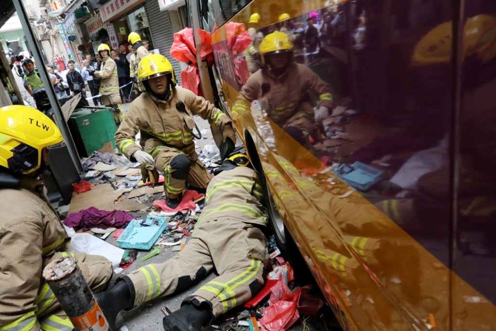 Firefighters at the scene after a school bus rolled down a slope and crashed into pedestrians in North Point on December 10. Photo: Dickson Lee