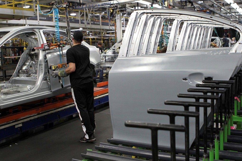 A worker installs doors on the new Chevrolet Cruze car as it moves along the assembly line at the General Motors Cruze assembly plant in Lordstown, Ohio, in 2011. Photo: Reuters