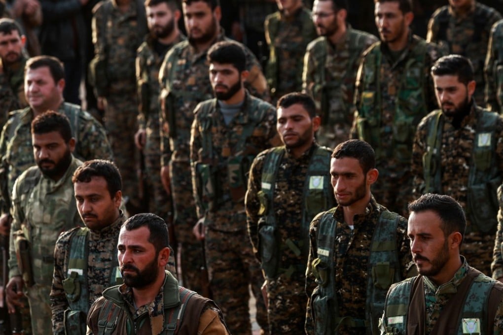 Syrian Kurdish members of the People's Protection Units (YPG) attend the funeral of a slain Kurdish commander in the northeastern city of Qamishli on December 6. Turkey considers the US-backed militia a “terrorist offshoot”. Photo: AFP