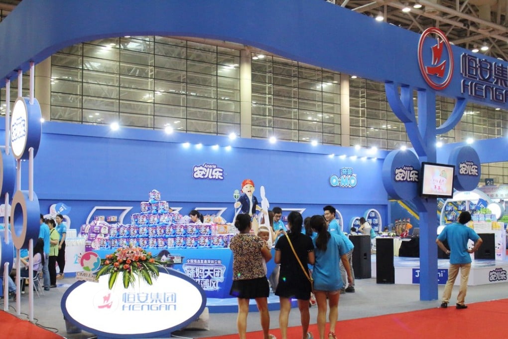 People visit the stand of Hengan International Group at a fair in Fuzhou city in southeast China on May 30 2014. Photo: Imaginechina