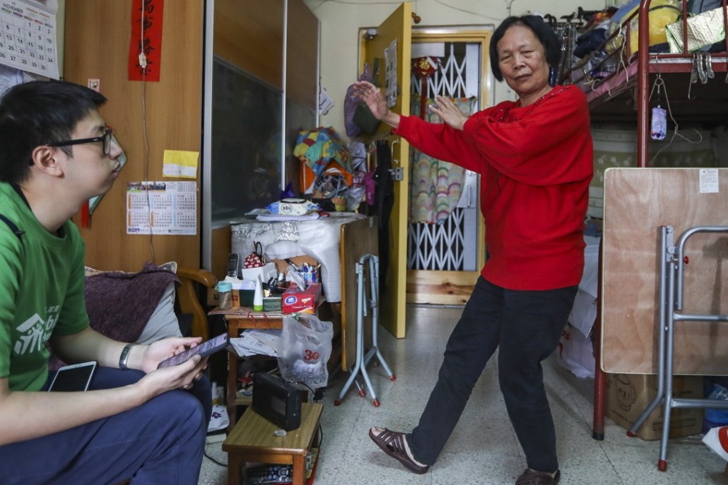 Ng Sau-fung (right), a beneficiary of Habitat for Humanity Hong Kong, shows off her tai chi moves in her home. Photo: Xiaomei Chen