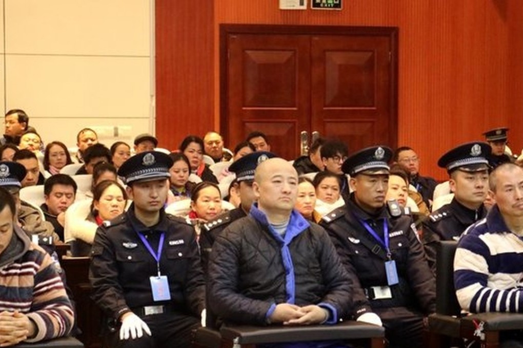 Shanxinhui founder Zhang Tianming (centre) and nine of his employees are sentenced in a Hunan court on Friday. Photo: CCTV