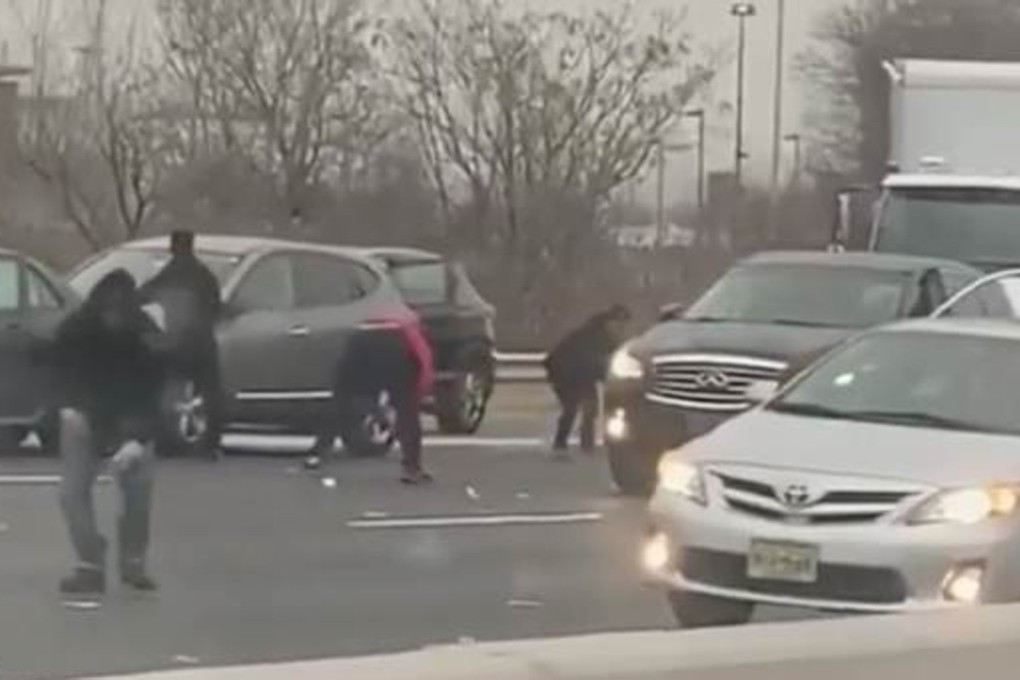 Drivers abandon their cars on a New Jersey highway to gather up cash the fell pout of an armoured truck. Photo: Twitter