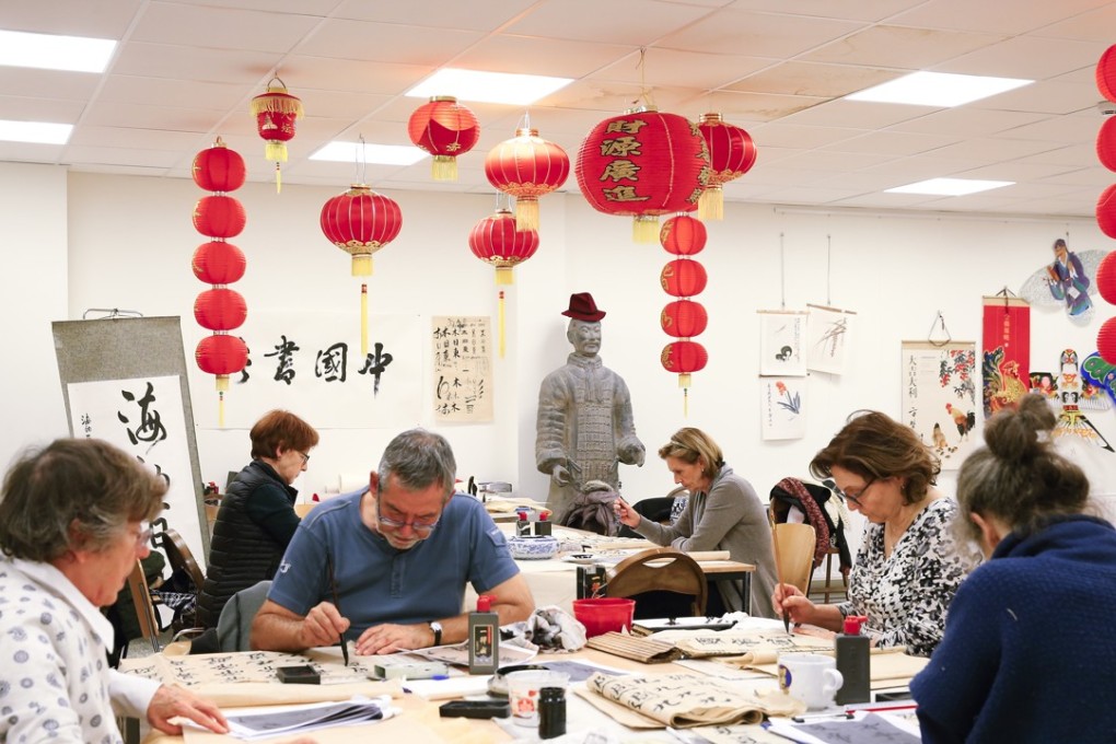 Students practise Chinese calligraphy at the Confucius Institute in Brussels. More than 500 of the institutes have opened around the world since 2004. Photo: Xinhua