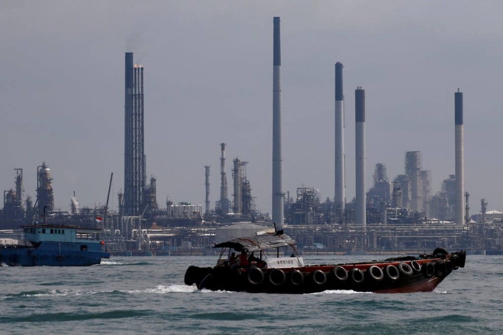 Boats sail past Pulau Bukom oil refinery along the southern coast of Singapore, where thieves made off with US$150 million worth of gas oil. Photo: Reuters