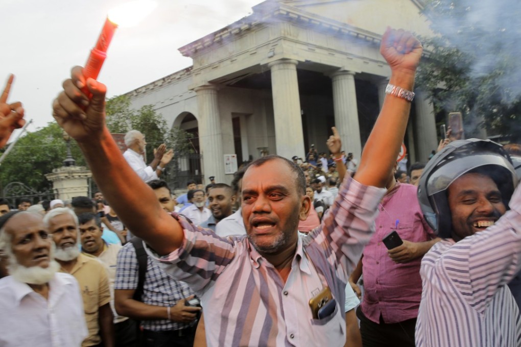 Supporters of ousted Sri Lankan Prime Minister Ranil Wickremesinghe celebrate the court’s verdict. Photo: AP
