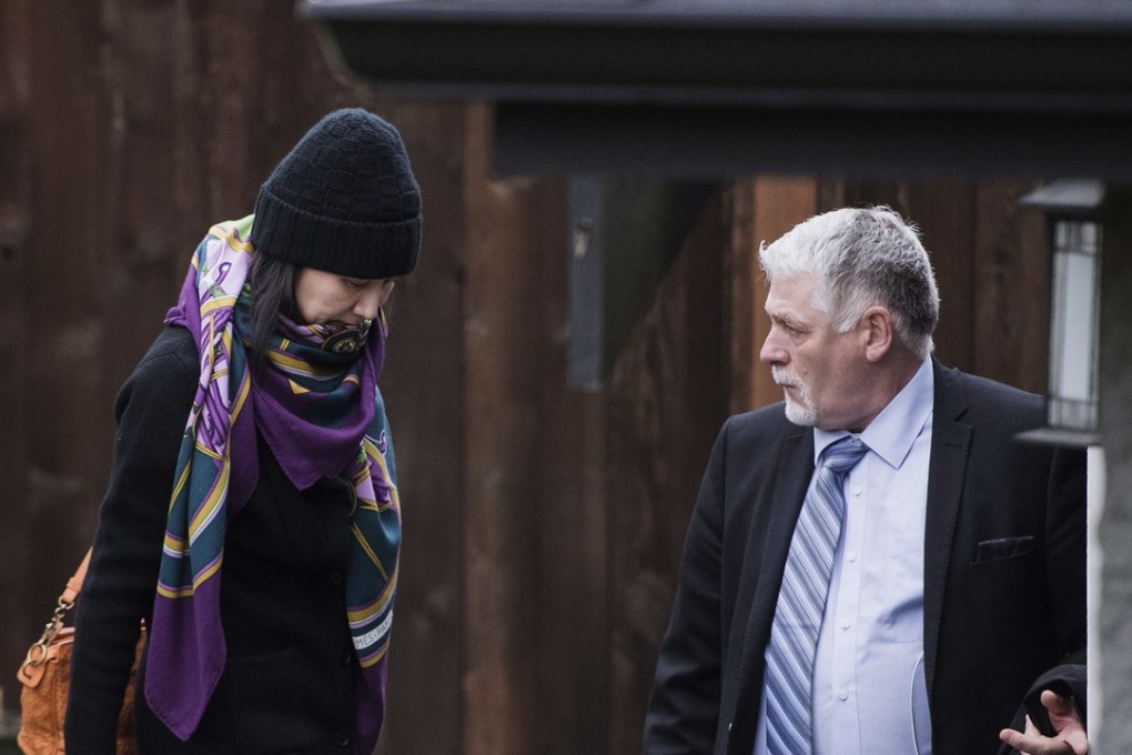 Huawei chief financial officer Sabrina Meng Wanzhou leaves her home, escorted by a security guard, in Vancouver on December 12. Photo: The Canadian Press via AP
