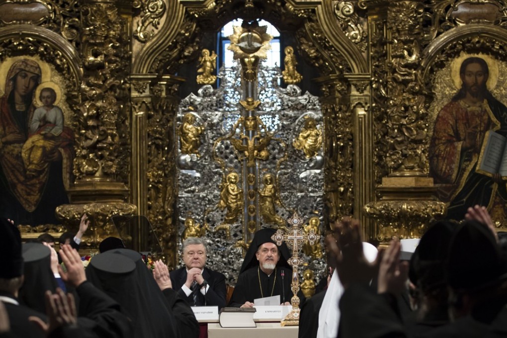Ukrainian President Petro Poroshenko, centre left, attends the closed-door synod of three Ukrainian Orthodox churches to approve the charter for a unified church. Photo: AP