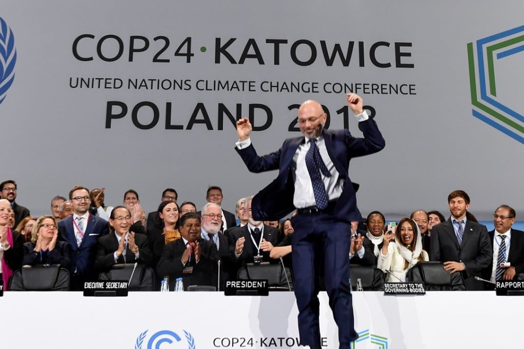 COP24 president Michal Kurtyka jumps at the end of the final session of the COP24 summit on climate change in Katowice, southern Poland, on December 15, 2018. Photo: AFP