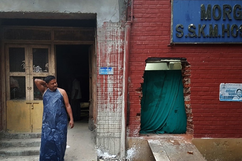 Sanjay Mallick, one of Kolkata’s Doms, takes a break from his work at the morgue. Photo: Sohini C