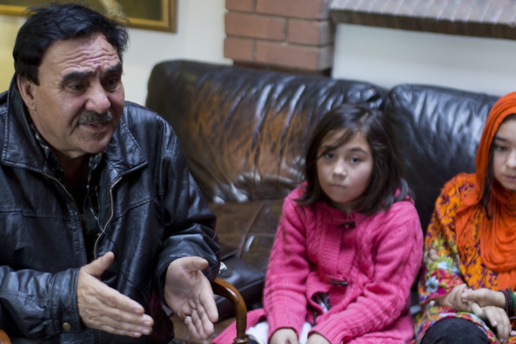 Mir Aman with his daughters Shahnaz (right) and Shakeela. Photo: AP