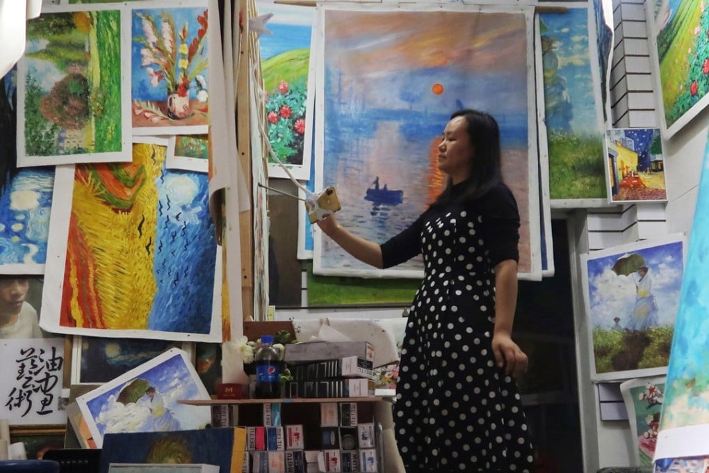Chinese artist Ma Chunyan, 32, reproduces a masterpiece from an image of the original displayed on her mobile phone at her studio in Dafen Oil Painting Village in Shenzhen, Guangdong province. Photo: Reuters