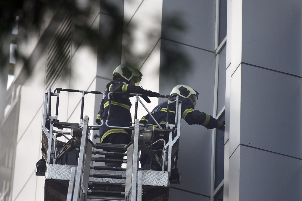 Firefighters attempt a rescue through a window of the hospital. Photo: AP