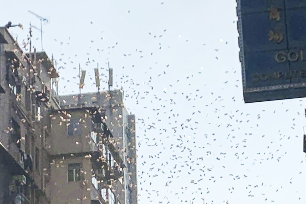 HK$100 banknotes rain from a rooftop in Sham Shui Po in a publicity stunt that sent crowds into a frenzy in one of the city’s poorest districts. Photo: Facebook