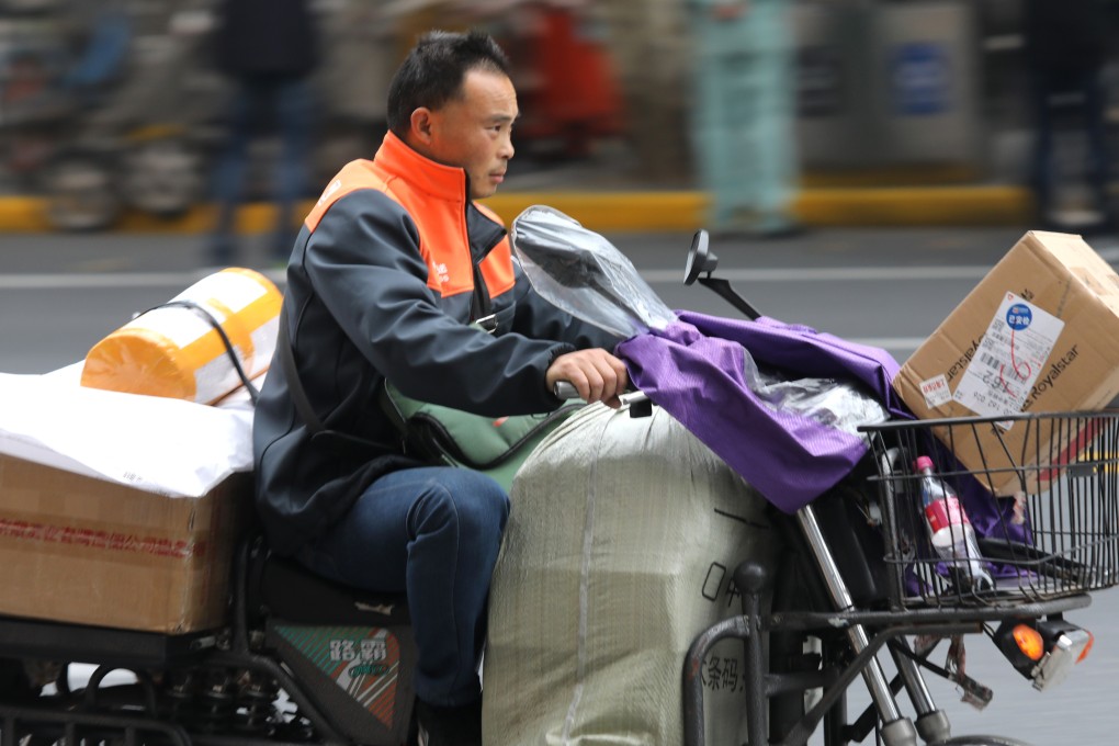 A man rides a motor bike to deliver goods for online shoppers in Shanghai on November 11, 2018. Some online retailers are offering customers the option of reusable packaging. Photo: SCMP/Simon Song
