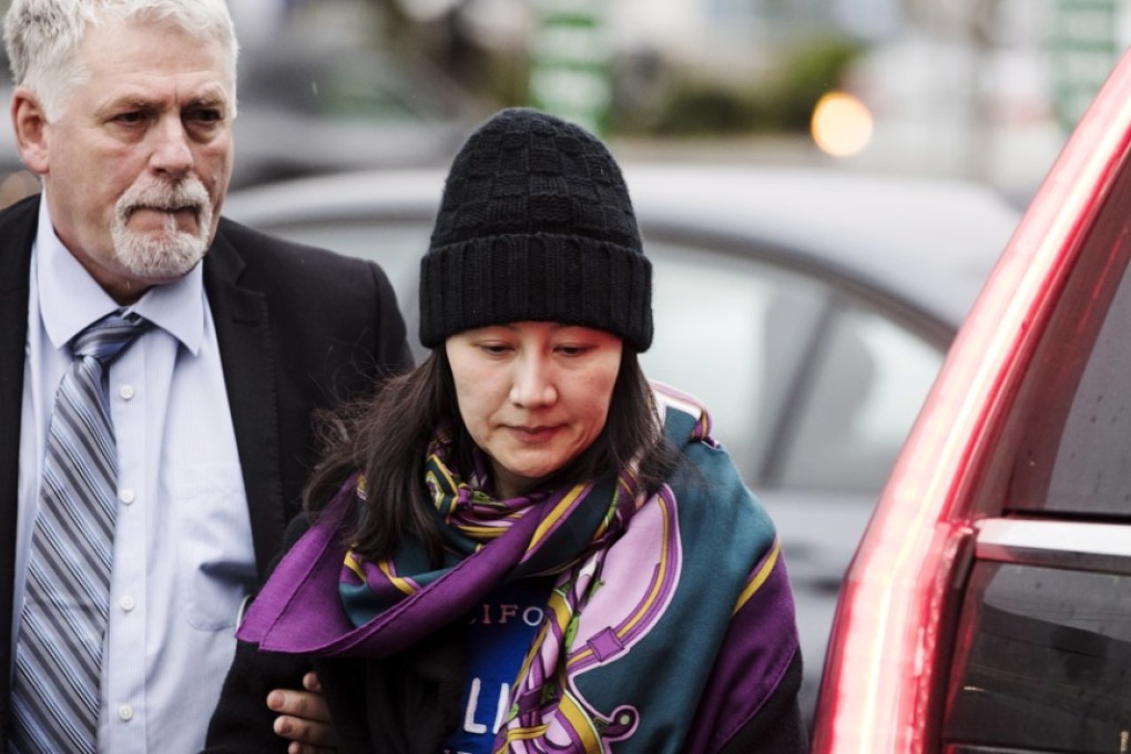 Huawei chief financial officer Sabrina Meng Wanzhou arrives at a parole office with a security guard in Vancouver, British Columbia, on Wednesday. Photo: AP