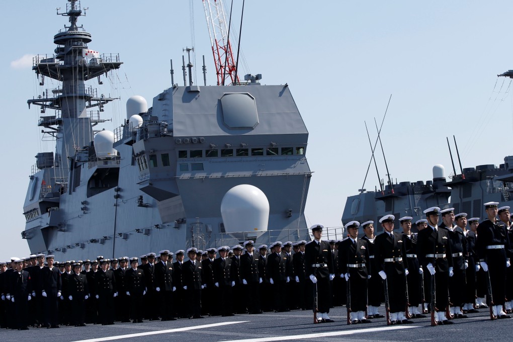 Members of the Japan Maritime Self-Defence Force attend a handover ceremony for the latest Izumo-class helicopter carrier JS Kaga (DDH-184) in Yokohama on March 22. Photo: Reuters