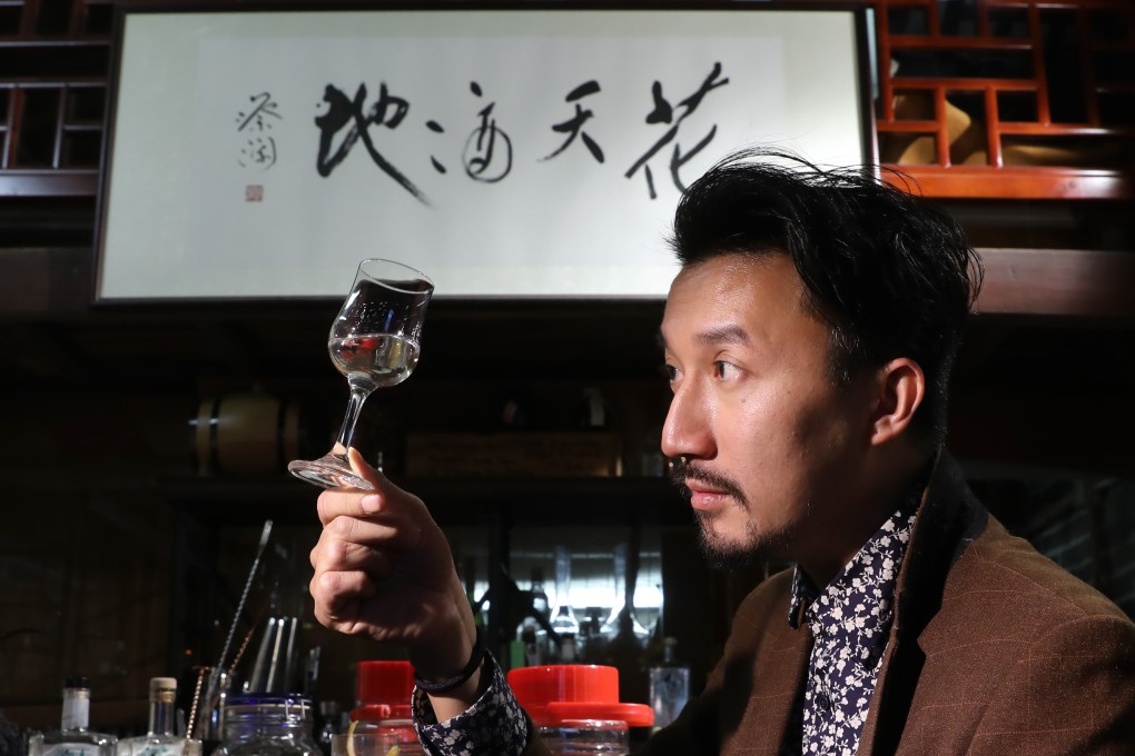 Kit Cheung holds up a glass of his creation, Perfume Trees Gin. Distilled using Hong Kong ingredients, it is produced in the Netherlands. Photo: K. Y. Cheng