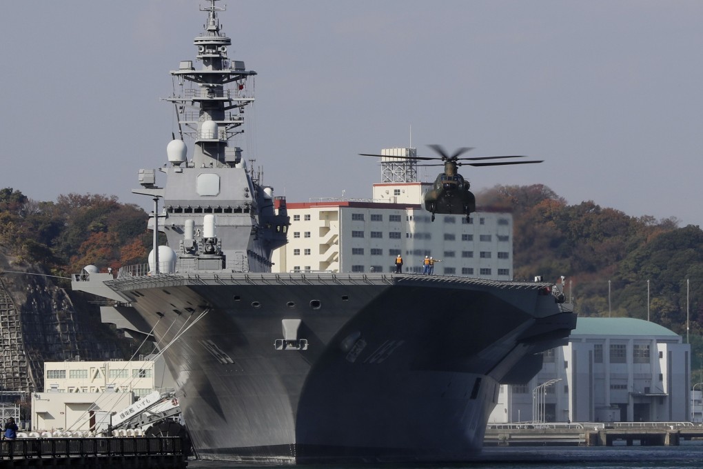 In this 2016 file photo, a helicopter prepares to land on the flight deck of the helicopter destroyer Izumo of Japan's Maritime Self-Defence Force. Photo: AP