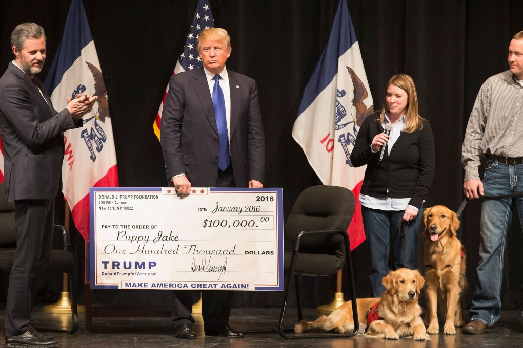 In this file photo taken on January 29, 2016, Donald Trump presents a cheque from the Trump Foundation to the Puppy Jake Foundation in Davenport, Iowa. It was two days before the Iowa caucuses for the Republican Party’s presidential nomination. Photo: Agence France-Presse