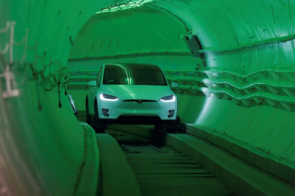 A modified Tesla Model X drives into the tunnel entrance before the unveiling event. Photo: Reuters