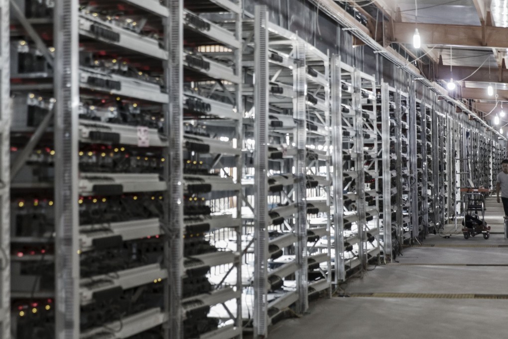A technician inspects bitcoin mining machines at a mining facility operated by Bitmain Technologies in Ordos in Inner Mongolia on Friday, August 11, 2017. Bitmain is one of the leading producers of bitcoin-mining equipment and also runs Antpool, a processing pool that combines individual miners from China and other countries, in addition to operating one of the largest digital currency mines in the world. Photo: Bloomberg