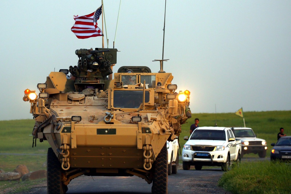 US forces, accompanied by Kurdish People's Protection Units (YPG) fighters, drive their armoured vehicles near the northern Syrian village of Darbasiyah, on the border with Turkey. Photo: AFP