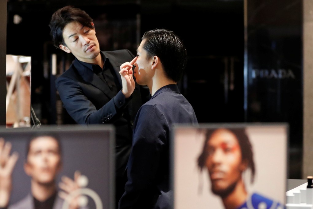 Model Masafumi and make-up artist Hiroki at a department store in Tokyo. Photo: Reuters
