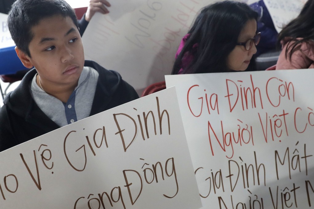Bill Nguyen, 12, and Jade Nguyen, 9, hold signs at a rally protesting President Donald Trump's deportation policy to deport Vietnamese refugees, at the Mary Queen of Vietnam Church in New Orleans. Photo: AP