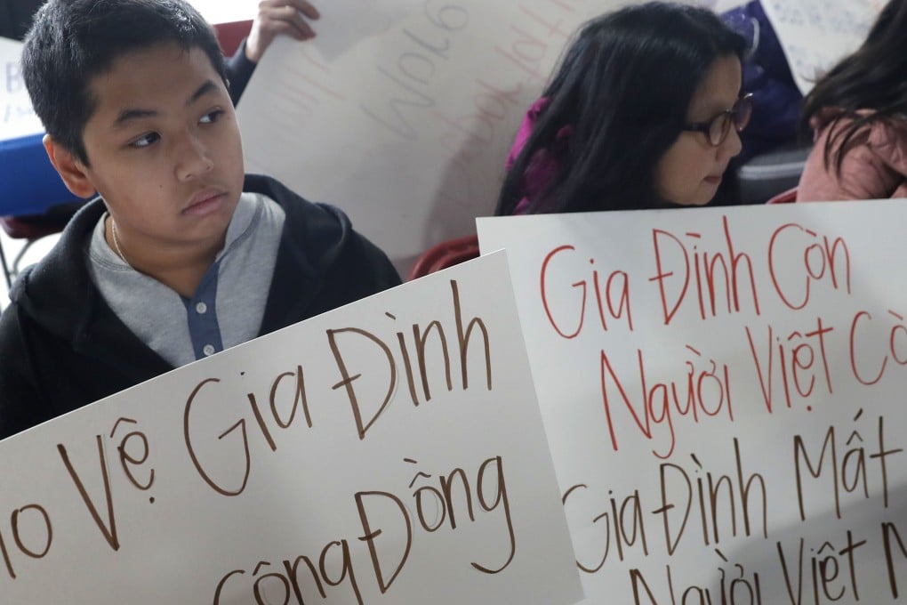 Bill Nguyen, 12, and Jade Nguyen, 9, hold signs at a rally protesting President Donald Trump's deportation policy to deport Vietnamese refugees, at the Mary Queen of Vietnam Church in New Orleans. Photo: AP