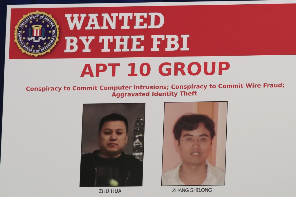 A poster displayed by the US Justice Department during a news conference on Thursday at which it announced charges against two Chinese citizens. Photo: AP