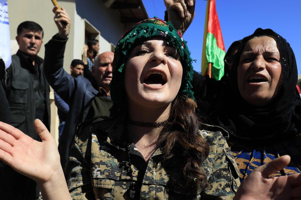 Syrian Kurds in the northeastern city of Qamishli protest against a Turkish assault on the Syrian border enclave of Afrin on March 11. Photo: AFP